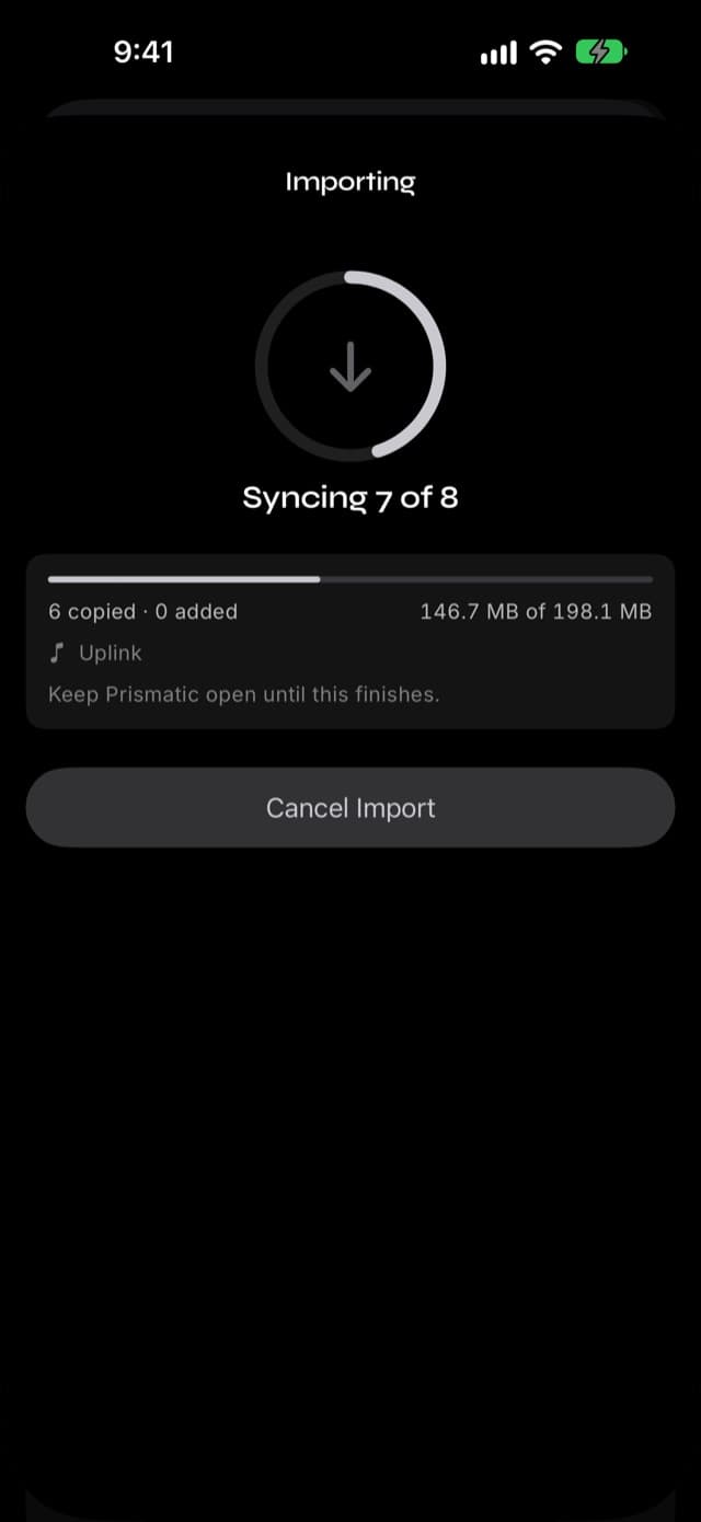 The import progress screen in Prismatic Music with a progress ring, the name of the song currently copying, and counts of copied and added songs