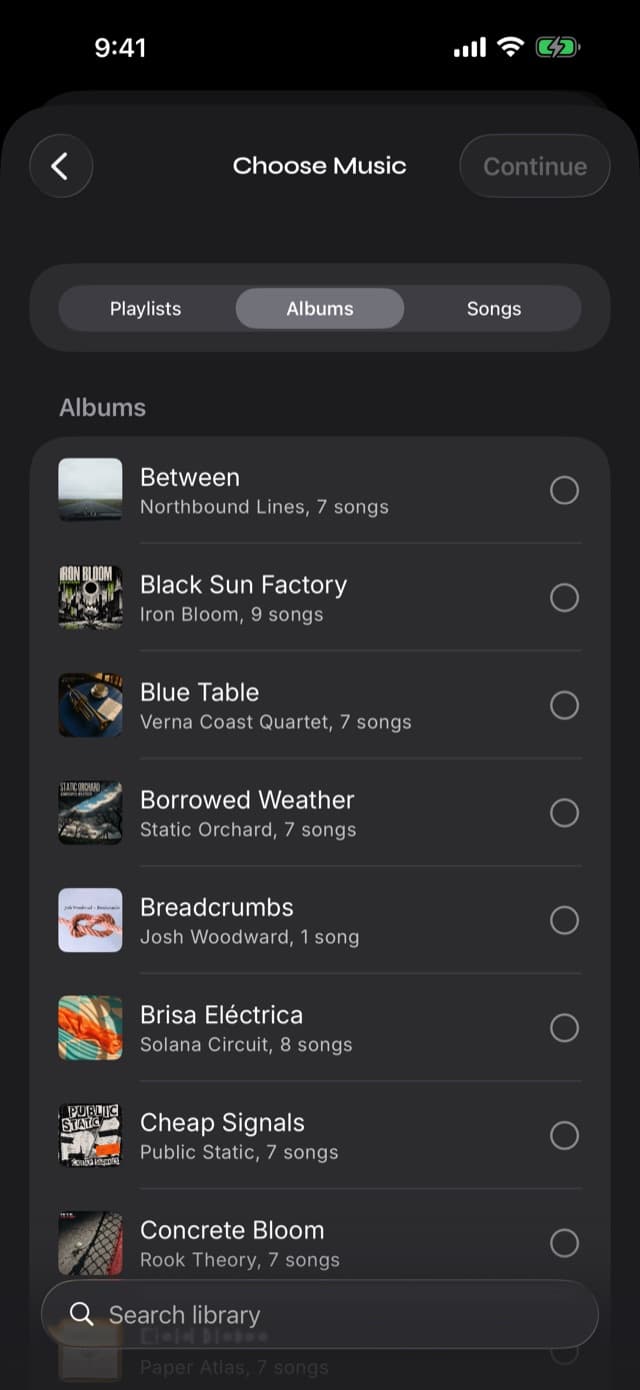 The Choose Music picker in Prismatic Music with Playlists, Albums, and Songs tabs and a scrollable list of albums with cover art and selection circles